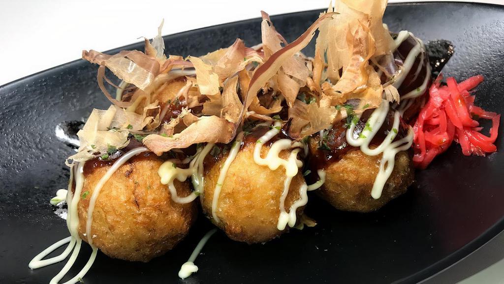 Takoyaki (9 pcs) · 9 pcs deep fried octpus filled balls, topped with takoyaki sauce and mayonnaise with bonito flakes.