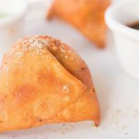 Veg Samosa(2 Pc) · Deep fried triangular shaped pastry studded with seasoned potatoes.