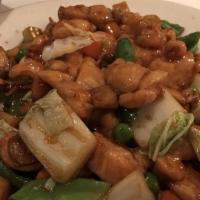 Cashew Chicken · Tender pieces of chicken wok tossed with carrots, onion, celery, and zucchini topped with go...