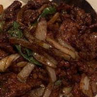 Mongolian Beef · Hot and spicy. Tender beef sautéed in a spicy dark sauce with green onions, white onions, an...