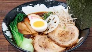 Yuzu Ramen · Soy sauce based chicken broth with a hint of Japanese yuzu citrus topped with braised pork belly slices, marinated soft-boiled egg, lotus root, fish cake, bamboo shoot, green onion and dried seaweed.