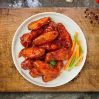 Spiced Up Wings · Fresh chicken wings breaded and fried until golden brown and tossed in hot sauce. Served wit...