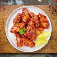 Cajun Craving Wings · Fresh chicken wings breaded and fried until golden brown and tossed in cajun sauce. Served w...