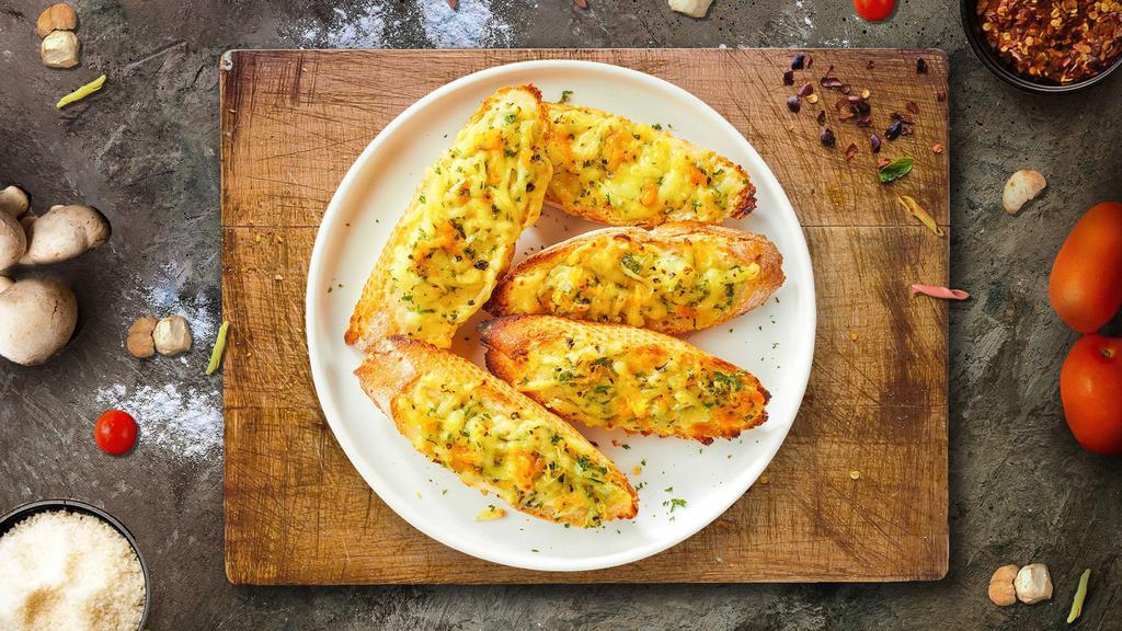 Cheesy Melt Garlic Bread · Housemade bread toasted and garnished with butter, garlic, mozzarella cheese, and parsley.