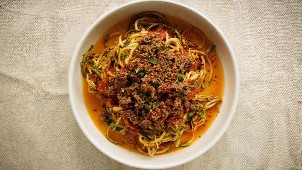 Ground Beef Marinara Zoodle · Zucchini spaghetti with homemade tomato sauce, ground beef and Parmesan. Gluten free.