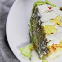 Iceberg Wedge Salad · Creamy danish blue cheese dressing, blue cheese crumbles, dill and toasted almonds.