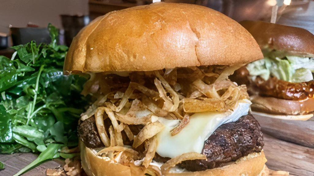 Brie Burger · 6oz burger topped with truffle oil, roasted garlic aioli & sweet fried onions served with a side salad