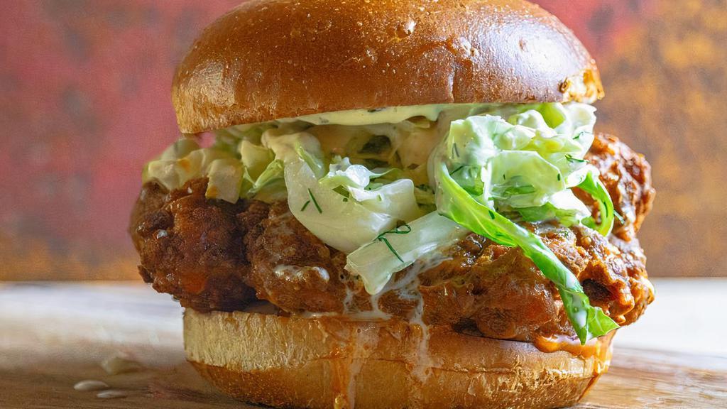 Nashville Spicy Fried Chicken Sandwich · Crunchy dill pickle coleslaw, buttermilk dressing, and a side salad