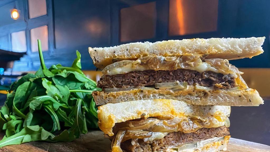 100% Vegan Patty Melt · Beyond Burger on toasted rye, caramelized onions, vegan mozzarella, vegan house aioli & pickles; served with a side salad