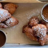 Ricotta Beignets · Housemade salted caramel and dark chocolate dipping sauces