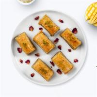 Peace With Pistachio Baklava · Two pieces of crispy and flaky Mediterranean pastry with pistachios.