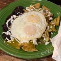 Chilaquiles · House made tortilla chips topped with two over easy eggs, queso fresco, green tomatillo, and...