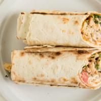 Chicken Shawarma Wrap · Chicken shawarma, grilled tomatoes, seasoned onions, pickles, garlic yogurt sauce topped wit...