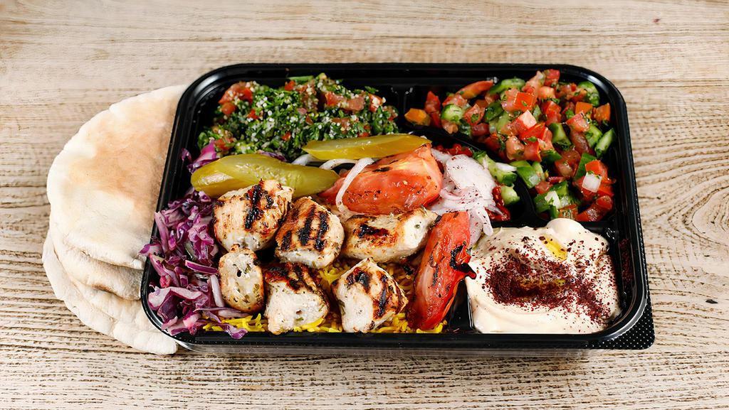 Chicken Kabob Plate · Chicken kabob skewer served
with tabouli, jerusalem salad, rice, hummus,  grilled tomatoes, seasoned onions with tahini sauce