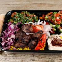 Lamb Kabob Plate · Lamb  kabob skewer served with tabouli, jerusalem salad, rice, hummus, grilled tomatoes, and...