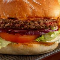 Impossible Burger (PLANT BASE MEAT) · Meatless burger on a bun with sauce, tomatoes, onion, lettuce and cheese. With a choice of f...