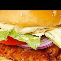 Fried Chicken Burger · Fried chicken on a bun with sauce, tomatoes, onion, lettuce and cheese. With a choice of fri...