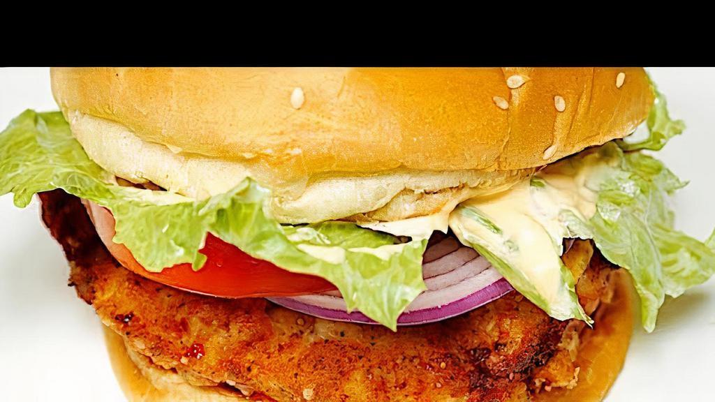 Fried Chicken Burger · Fried chicken on a bun with sauce, tomatoes, onion, lettuce and cheese. With a choice of fries or jerusalem salad.