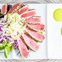 Ahi Tuna Steak Salad · Ahi tuna seared rare, organic mixed greens, cabbage, light soy dressing, wasabi sauce.