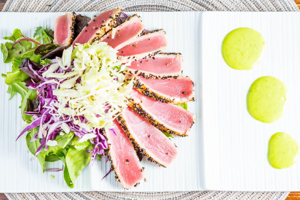 Ahi Tuna Steak Salad · Ahi tuna seared rare, organic mixed greens, cabbage, light soy dressing, wasabi sauce.