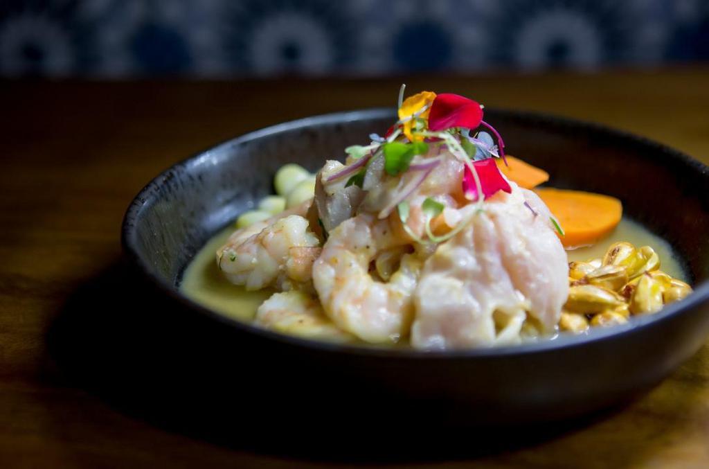 Ceviche mixto · Fresh catch of the day, calamari, & shrimp in our clasico leche de tigre. Served with choclo, cancha, & sweet potato.