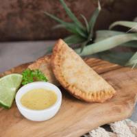 Beef empanadas · Two crispy pastries filled with: Hand cut top sirloin sauteed in aji Panca, eggs, olives, & ...