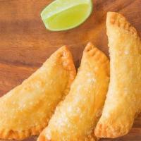 Veggie Empanadas · Two crispy pastries filled with: Roasted mushroom, spinach, choclo, oaxaca cheese.