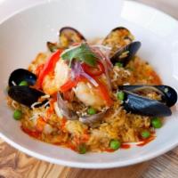 Arroz con mariscos · Aromatic saffron rice cooked in Ají Amarillo & Ají Panca fish fumé. Comes with fresh mussels...