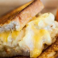 Mac and Cheese Grilled Cheese · Mac n cheese stuffed into a garlic buttered grilled cheese on sourdough (vt) .