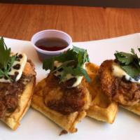 Fried Buttermilk Chicken On A Waffle · Fried buttermilk chicken on a Brussels style waffle with date butter and syrup...