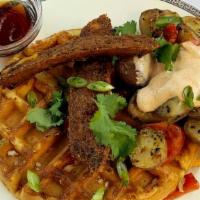 Loaded Chicken Sausage Waffle · Chicken sausage, with cheddar cheese, cilantro, home fries, and green onions. Served with sy...