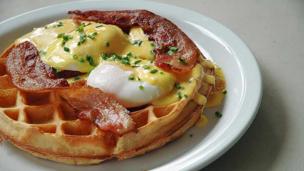 Petillon Waffle · two eggs your way (Options as: sunny
side, over easy, over hard, scrambled,
and poached), bacon and hollandaise. Served with syrup.