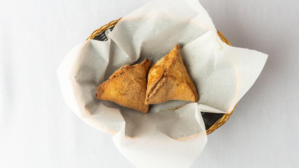 Vegetable Samosa · Crispy patties stuffed with potatoes and peas with mild aromatic spices.