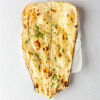 Garlic Naan · Leavened flour bread stuffed with garlic and spices and baked in the tandoori oven.