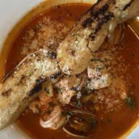 Cioppino Alla Livornese · Seafood stew of prawns, fish, clams, baby squid and scallops with grilled garlic bread.
