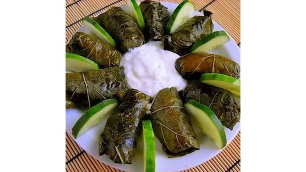 Dolma · Vegetarian stuffed grape leaves, lettuce, cucumber and Tzatziki sauce.