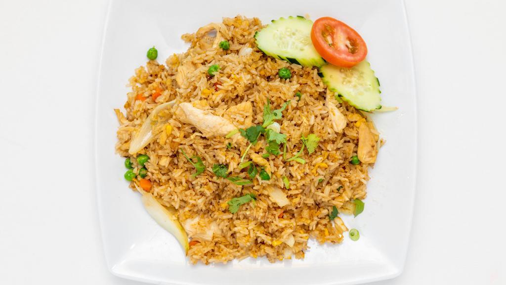 Thai Fried Rice · Pan-fried Rice with egg, onion, carrot, peas, and choice of protein with cucumber, tomatoes, and cilantro as garnishes.