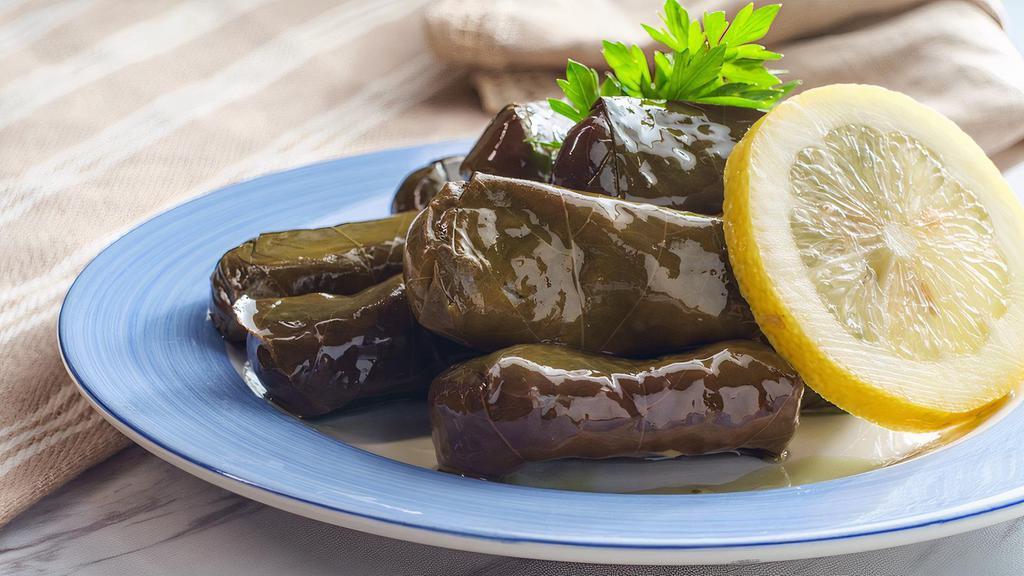 Dolmeh (6 Pieces) · Grape leaves stuffed with rice.