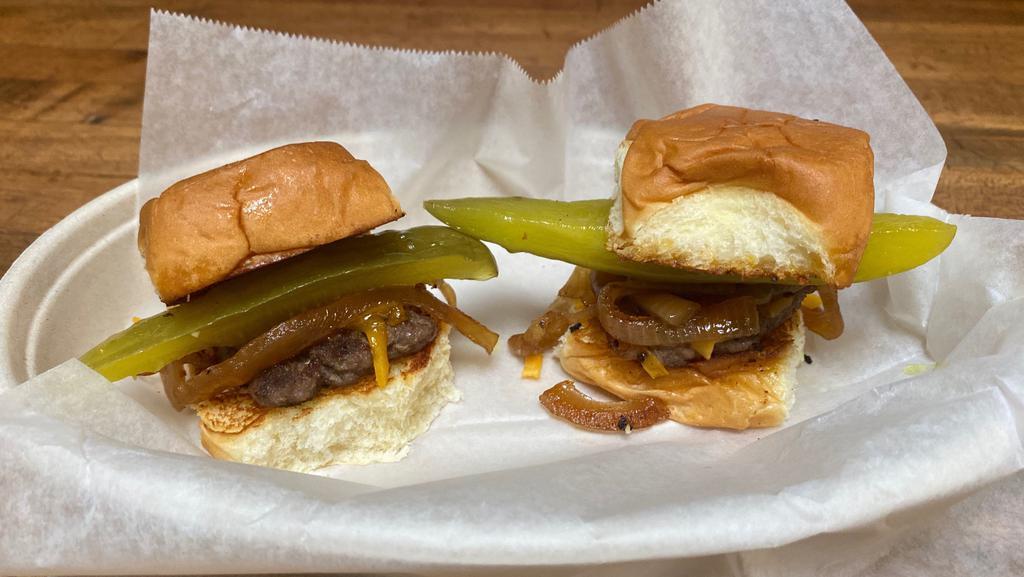 Sliders ( 2 ) · Seasoned beef patty, cheddar cheese,
pickle and caramelized onions  on a Kings Hawaiian Bun.