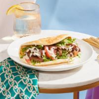 Lamb Shawarma Wrap · Juicy lamb with hummus, lettuce, tomato, and red onion drizzled with your choice of sauce an...