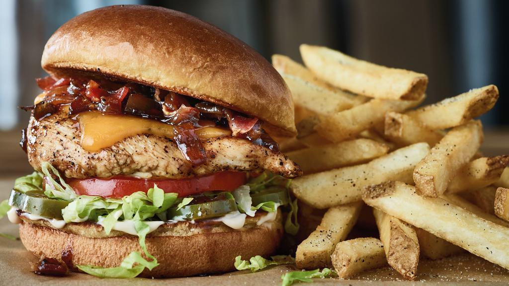 Jammin’ Grilled Chicken Sandwich · Grilled chicken, Cheddar cheese, bacon onion jam, pickled jalapeños, aioli. Served with perfectly seasoned crispy fries.