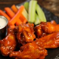 Traditional Classic Buffalo · 8 classic buffalo wings (medium heat), served with carrots & celery and a choice of blue che...