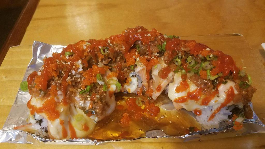 Fire Mountain Roll (Spicy, Half-Cooked) · Spicy. Inside: imitation crab, and avocado. Top: salmon, spicy tuna, and Sriracha.
