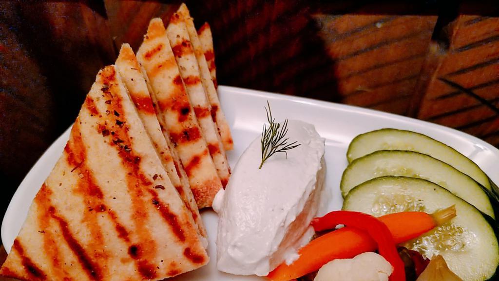 Taramosalata/Cod Roe · Traditional Greek spread of whipped cod roe and bread. Served with house made grilled pita, cucumber and pickles.