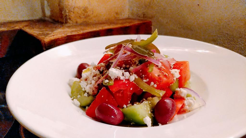 Horiatiki/Greek Salad · Classic greek salad of tomato, cucumber, bell pepper, onion, oregano, olives, and feta.