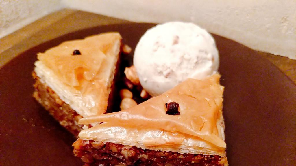Baklava · Traditional baklava drizzled with honey syrup served with vanilla ice cream.