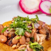 Pollo Asado Taco · Corn tortilla, grilled chicken, cilantro, onions, and pinto beans. Complimentary garnish: ra...