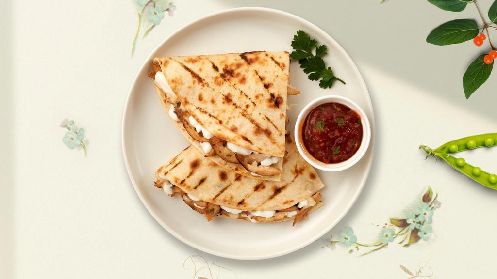 Just Kidding Quesadilla · Kid size quesadilla with cheese in a grilled tortilla.