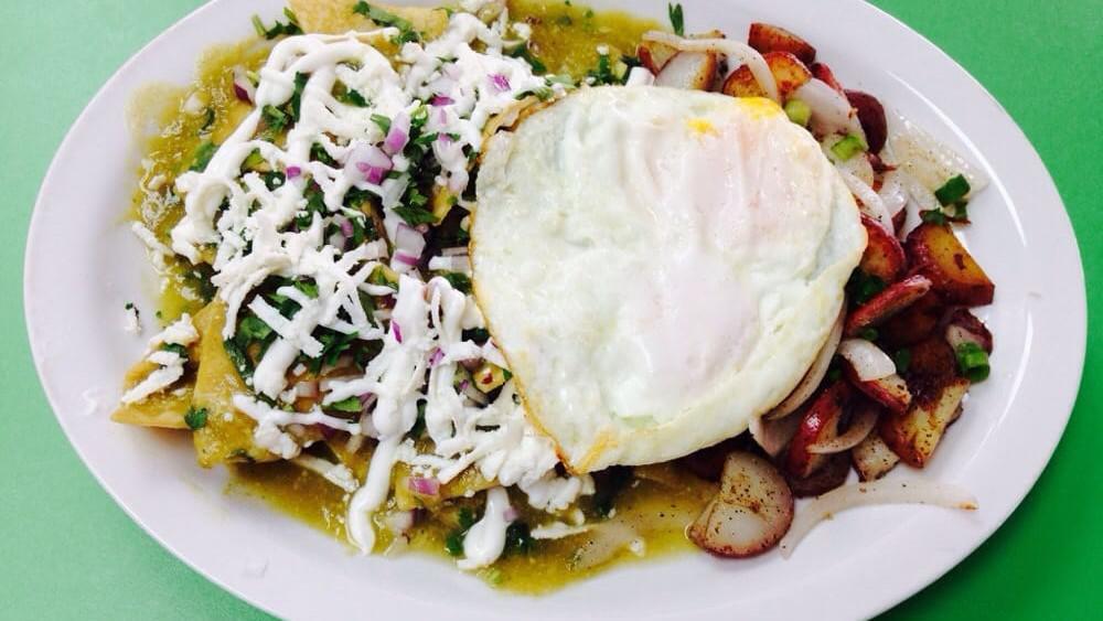 Chilaquiles · Crispy tortillas, Jack cheese, red onions, cilantro, sour cream, queso fresco, eggs any style with green or red sauce and home potatoes.