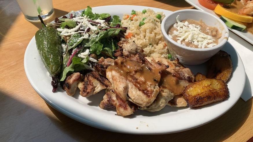 Pollo Asado ala Parrilla · Two chicken thighs adobo marinated and cooked to order with fried plantains.